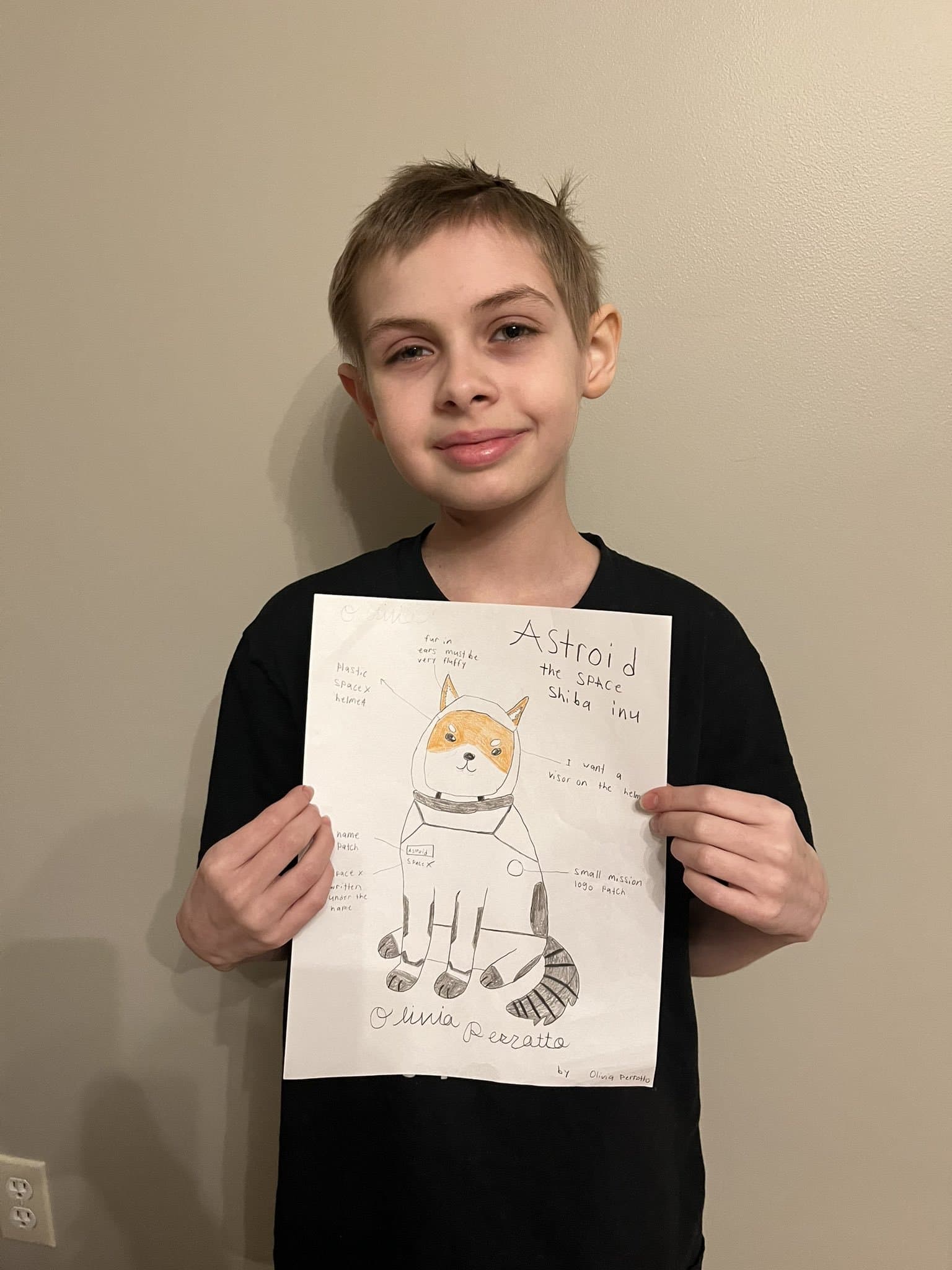 LIV during treatment, after losing her hair to radiation, holding the Asteroid Shiba Inu drawing